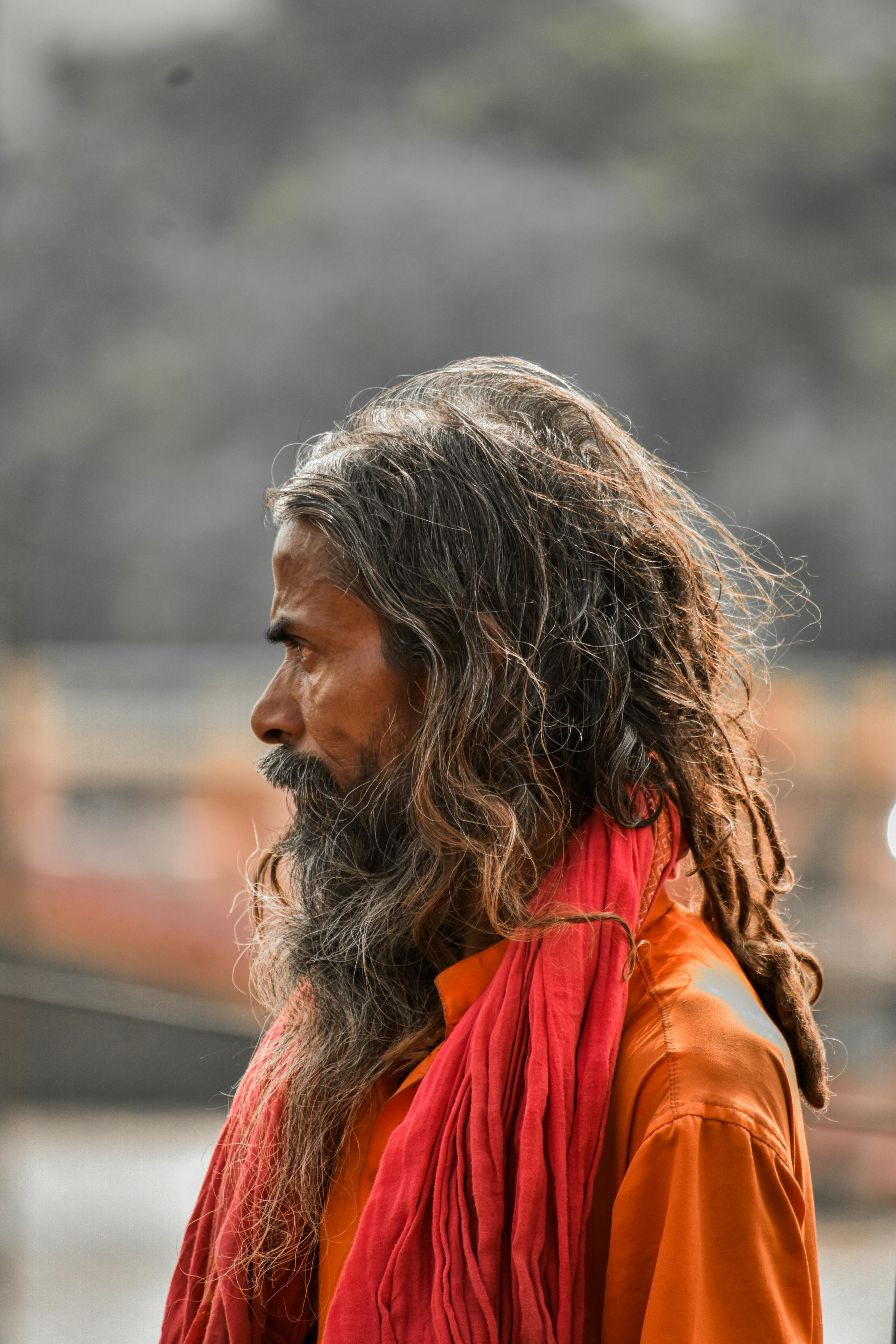 Illustration Of Religious Indian Sadhu Man Sitting Atop Of Hill Overlooking  The City At Dusk. Old Man With White Beard Pondering About Life. Indian  Cityscape With Hindu Elder. Generative Ai Stock Photo,