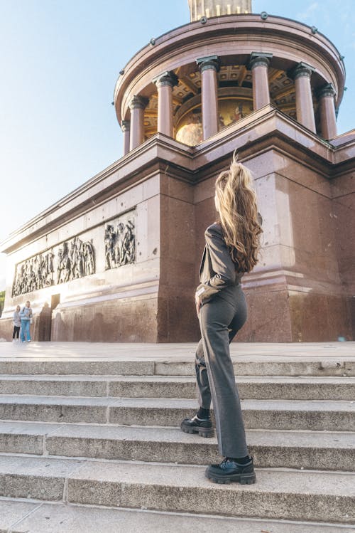 Tourist in a Gray Blazer and Pants at Steps of Berlin Victory Column