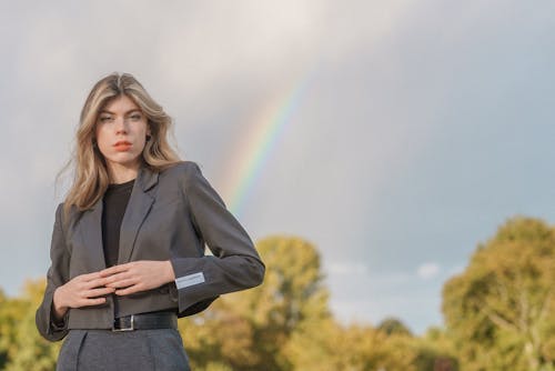 Young Model in a Gray Blazer Against the Sky with a Rainbow