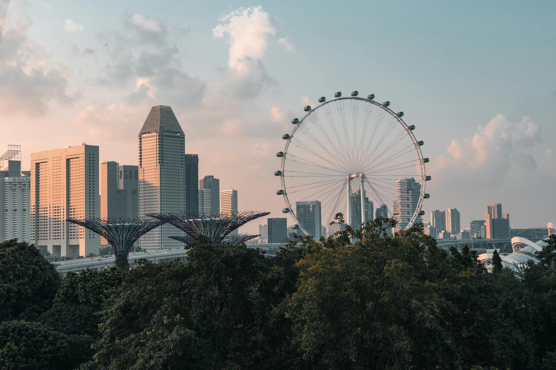 A breathtaking view of Singapore's skyline including the Singapore Flyer at sunset.