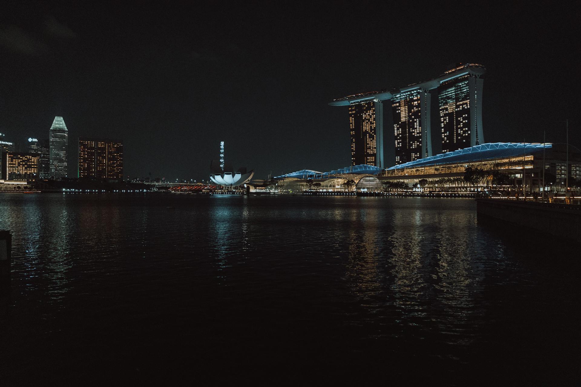 Captivating night view of Singapore skyline featuring Marina Bay Sands and cityscape reflections.