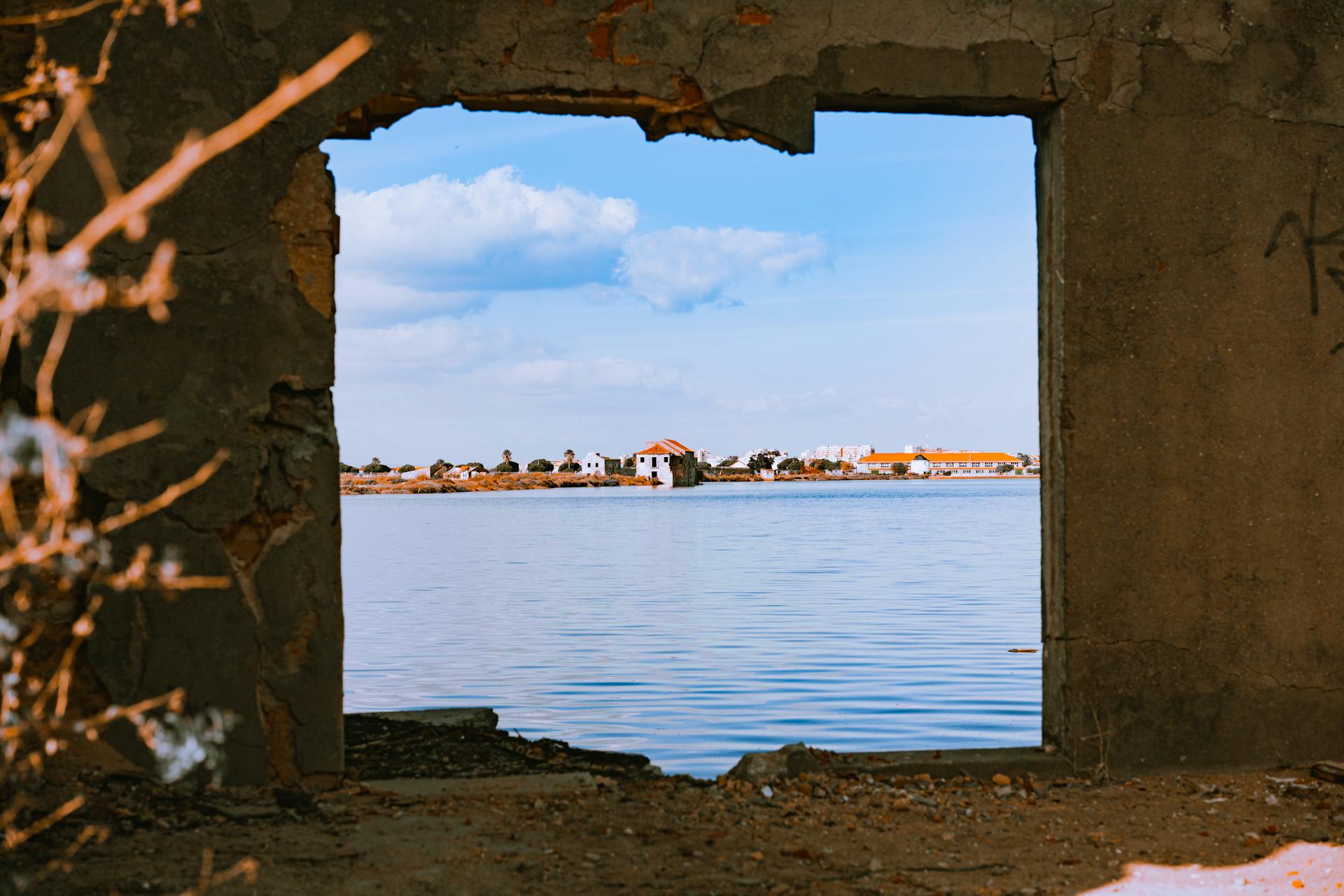 River and Town behind Window Opening in Damaged Wall