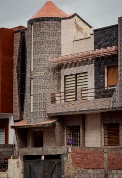 A visually striking urban building with unique brick design and balconies.