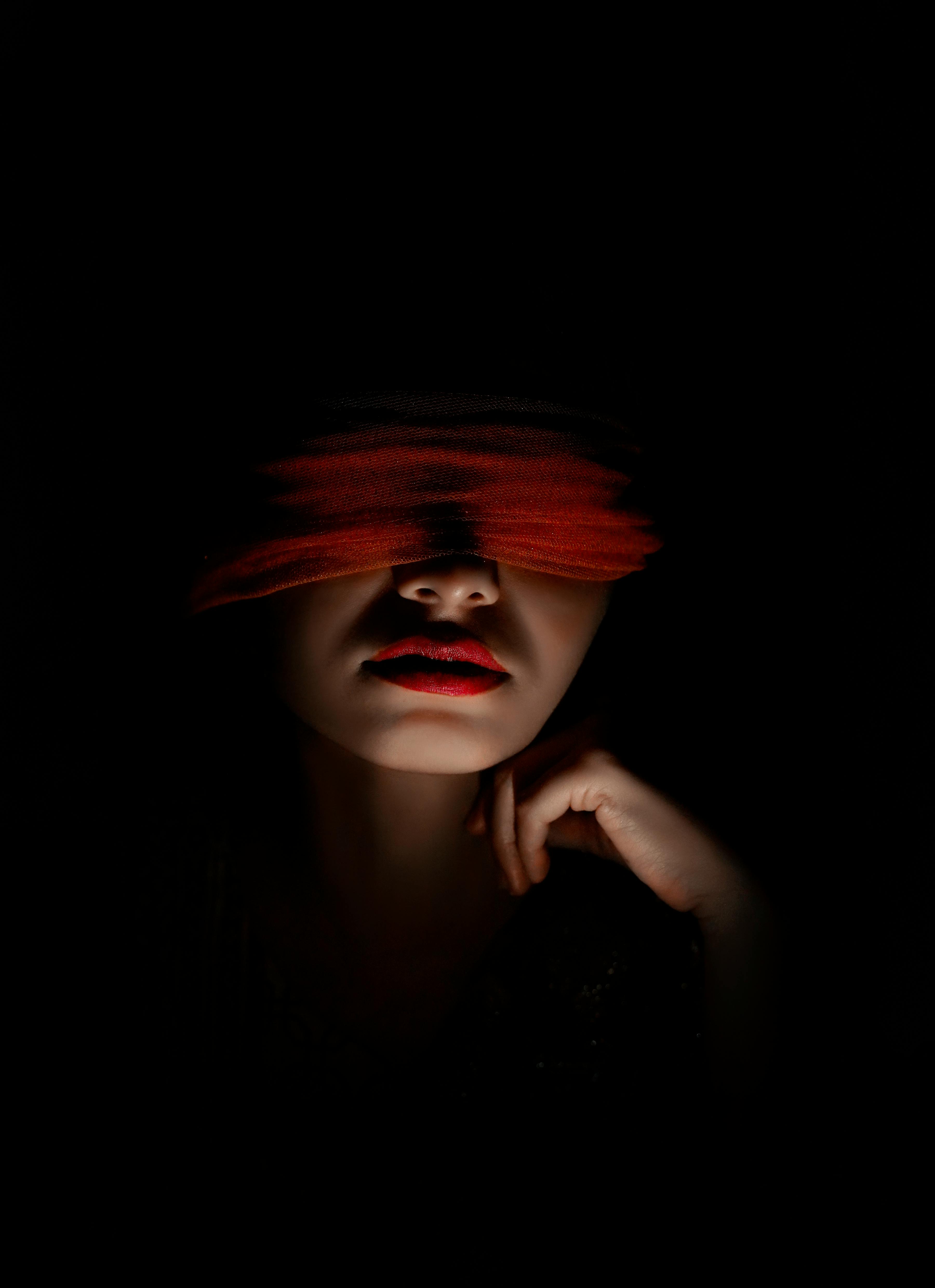 Dark Studio Shot of a Blindfolded Woman · Free Stock Photo