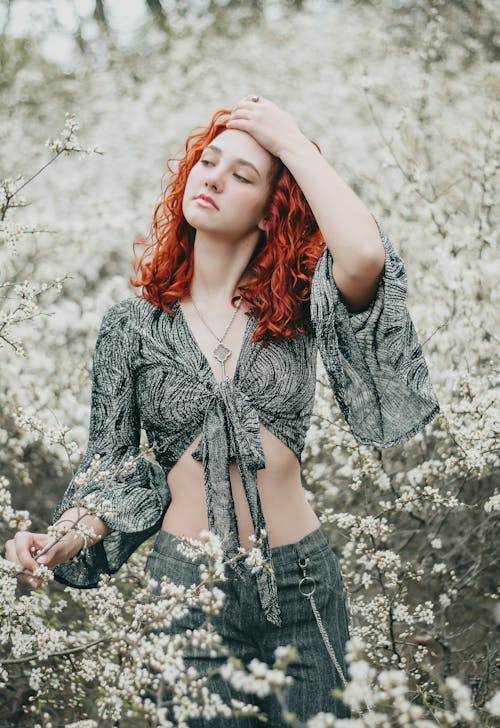 Free Redhead Woman on Meadow with Flowers Stock Photo