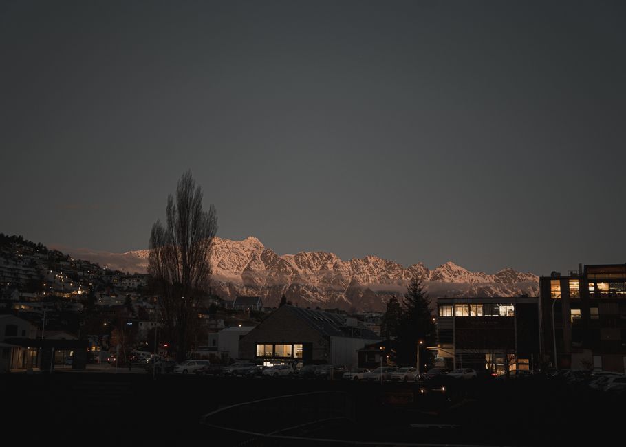 Unbeatable Queenstown Helicopter Experience Exclusive Earnslaw Burn Glacier Review Review 2026 - Dusk view of Queenstown, New Zealand with a stunning mountain backdrop and city lights.