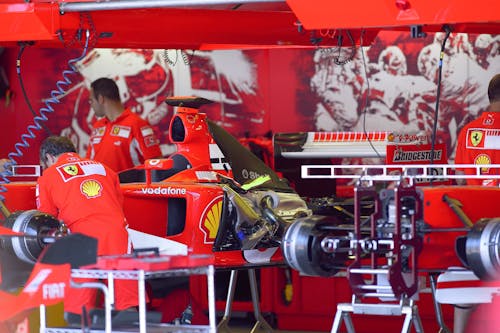 Ferrari Mechanics Working on the Ferrari F2005 Race Car during a Race Weekend 