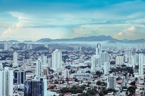 Free High-angle cityscape featuring tall skyscrapers under a bright blue sky. Stock Photo