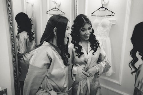 Young Brunette Women Posing in Satin Robes in a Dressing Room