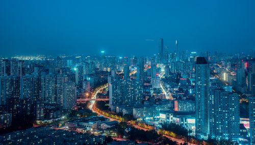 Free A vivid cityscape at night showcasing illuminated modern architecture and urban life. Stock Photo