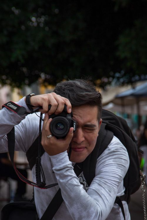 Free Portrait of a man taking photos outdoors in Santiago de Querétaro, Mexico. Stock Photo