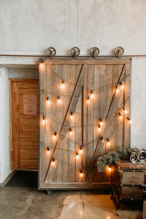 Free Yellow String Lights On Brown Wooden Door Stock Photo