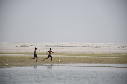 Boys Playing Ball on Beach