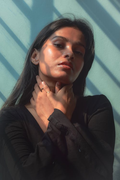Young Woman with her Hands on her Neck 