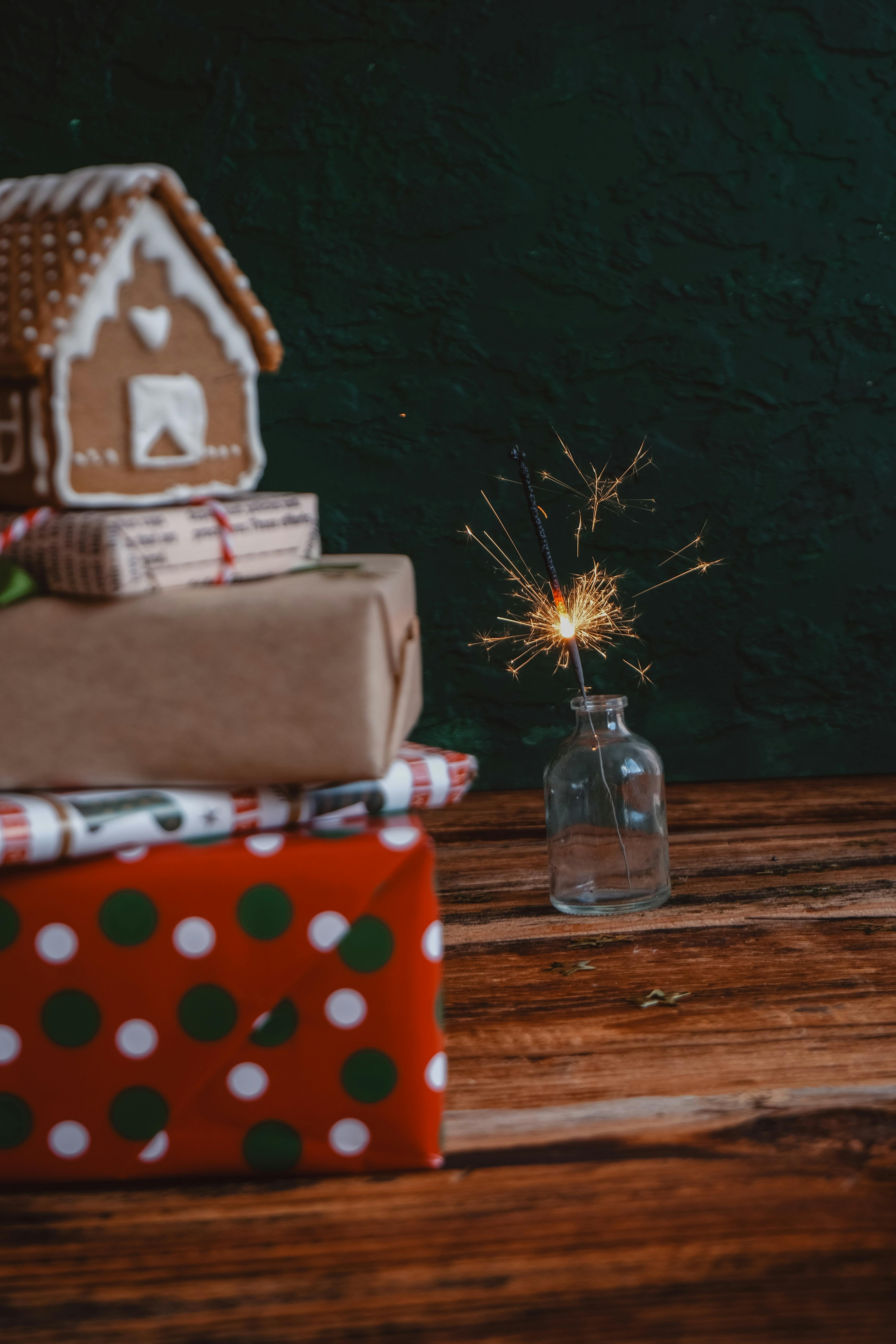 Gingerbread House on a Stack of Wrapped Christmas Gifts · Free Stock Photo