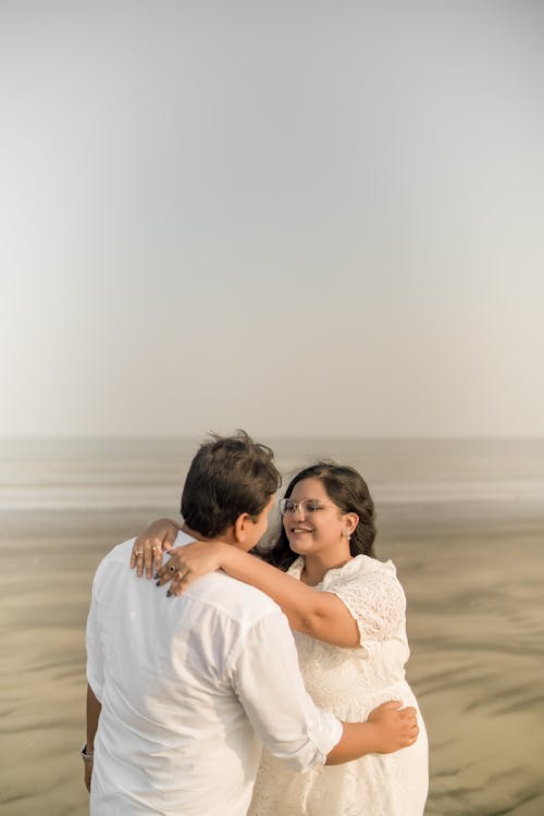 Embracing Couple on a Sandy Beach