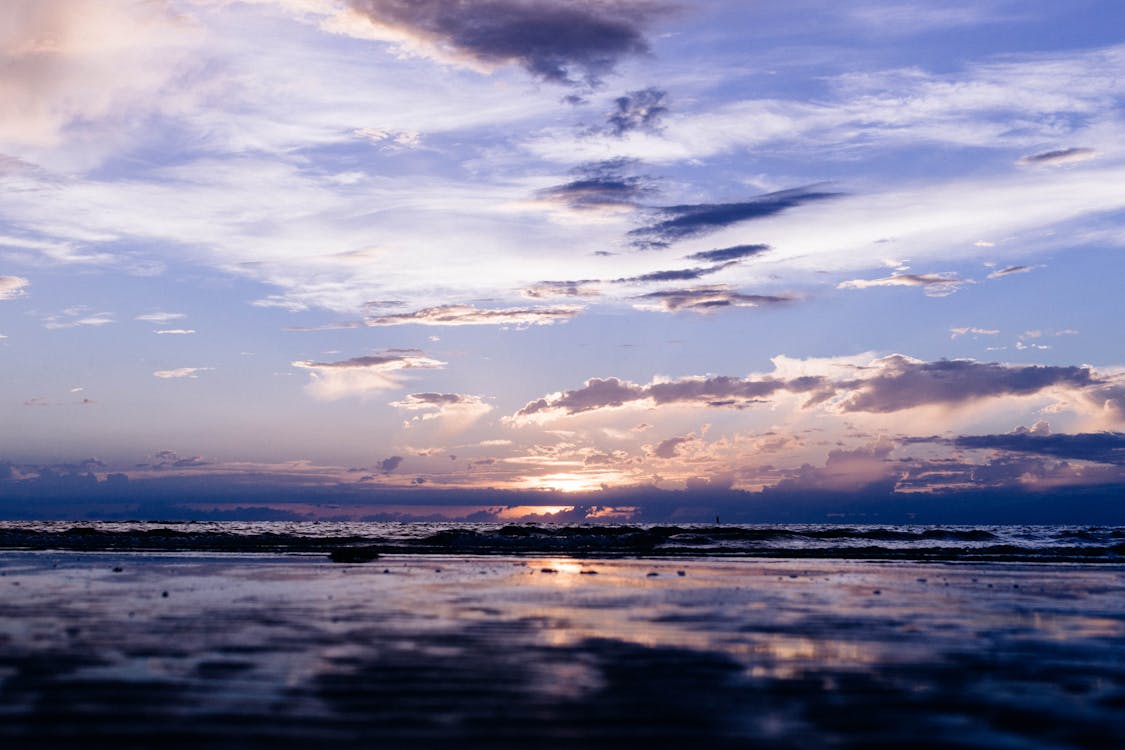 Free Silhouette Photography of Body of Water Under Clouds Stock Photo