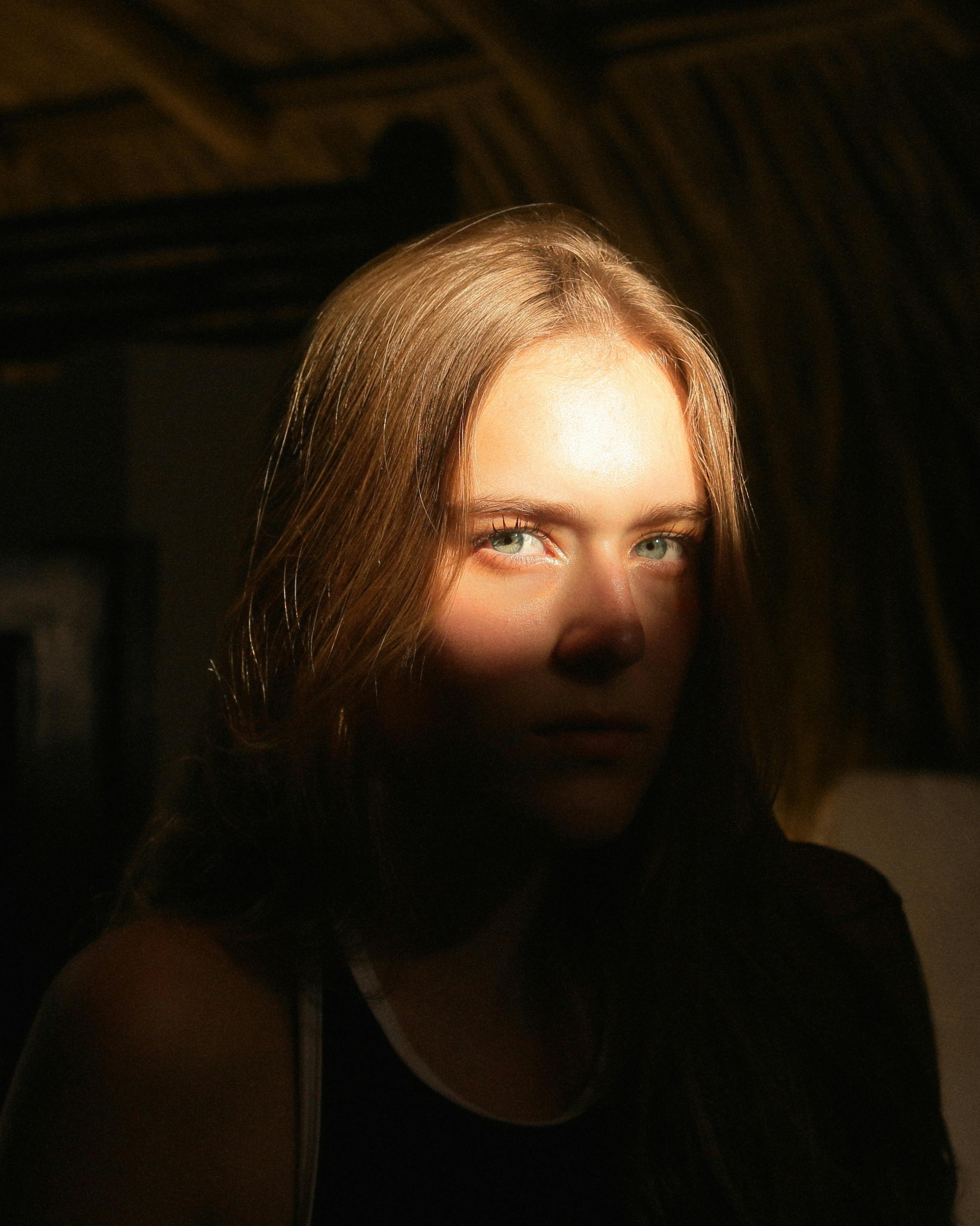 a woman with long hair and a dark background