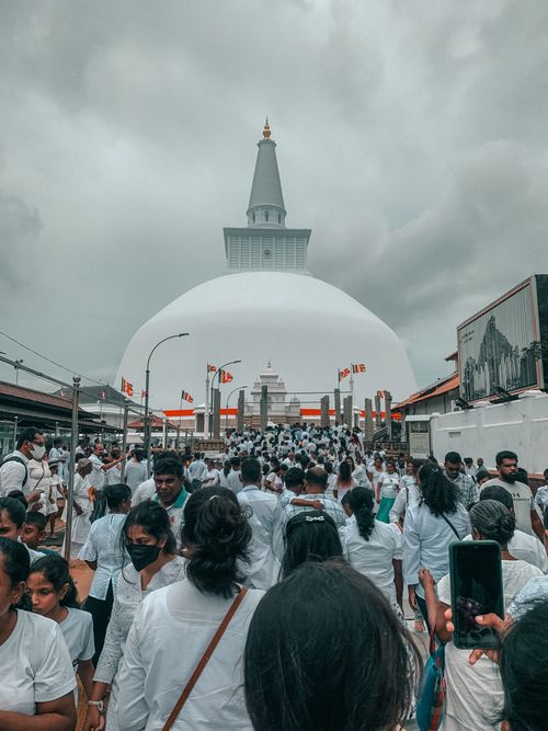 Free A crowd gathers at the Ruwanweli Maha Seya Temple in Anuradhapura, Sri Lanka, showcasing cultural and religious significance. Stock Photo