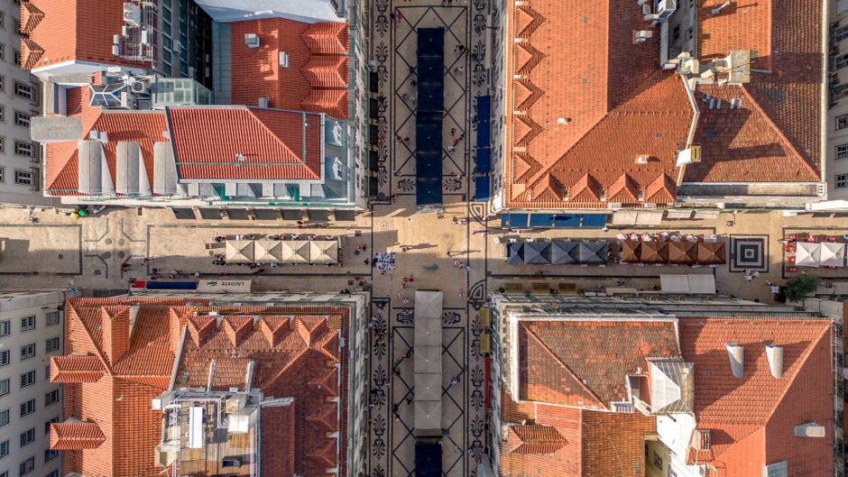 Aerial view of Lisbon's vibrant streets and terracotta rooftops showcases urban charm. — Baixa, Portugal.