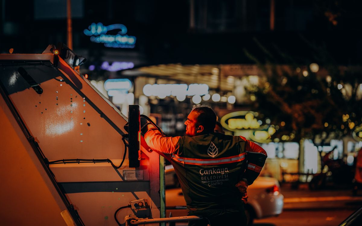 Sanitation worker in Ankara doing urban night work, enhancing city cleanliness.