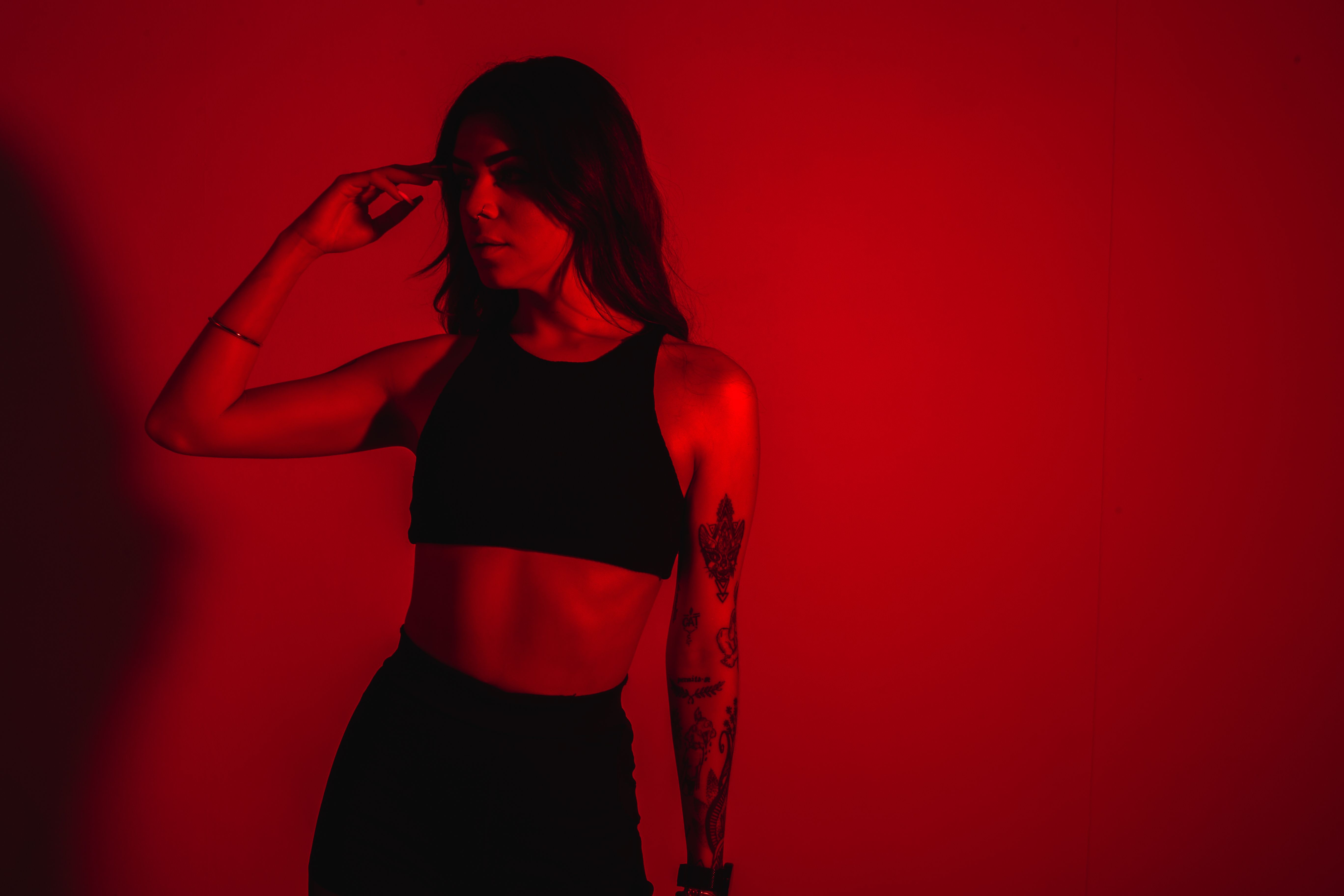 Model with Tattoos on Red Background · Free Stock Photo