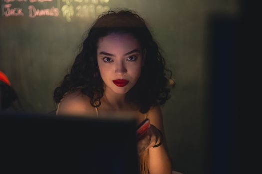 A Woman in a Dim Light in Seductive Pose