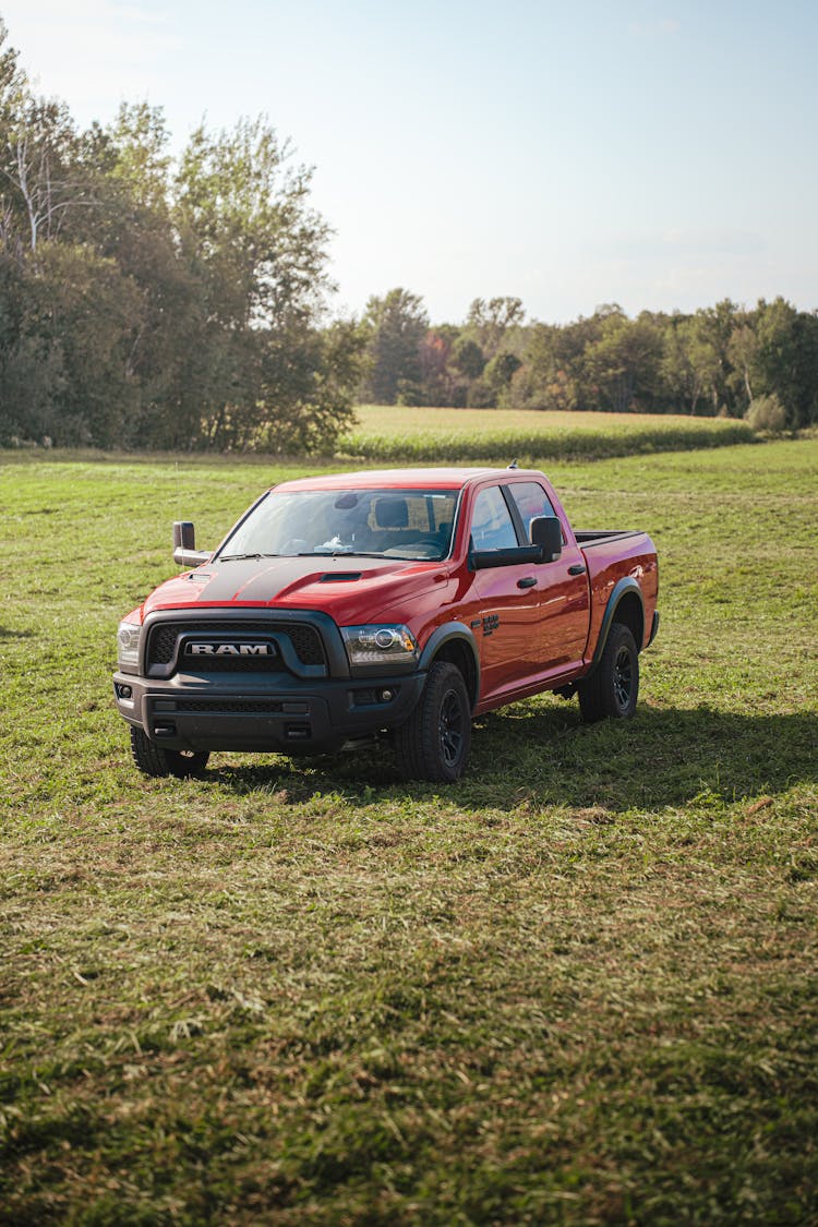 Red Pickup Truck Ram Rebel Parked In A Pasture