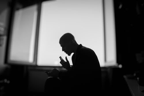 Bald Man Smoking in Darkness