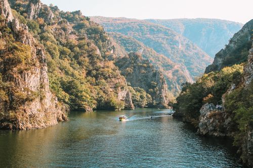 Free Explore the scenic beauty of Matka Canyon in North Macedonia with a boat ride through rugged cliffs and lush greenery. Stock Photo