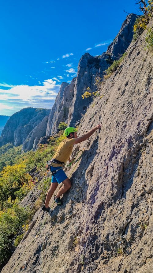 Free Man Climbing a Rocky Mountain Stock Photo