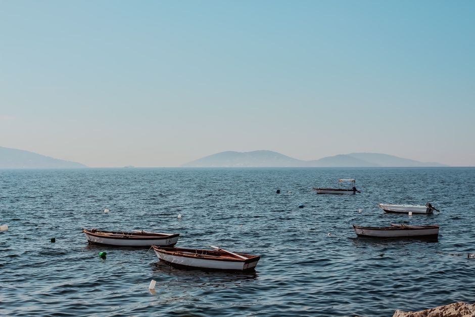 Serene view of boats floating on the sea in Adalar, İstanbul during a clear summer day.