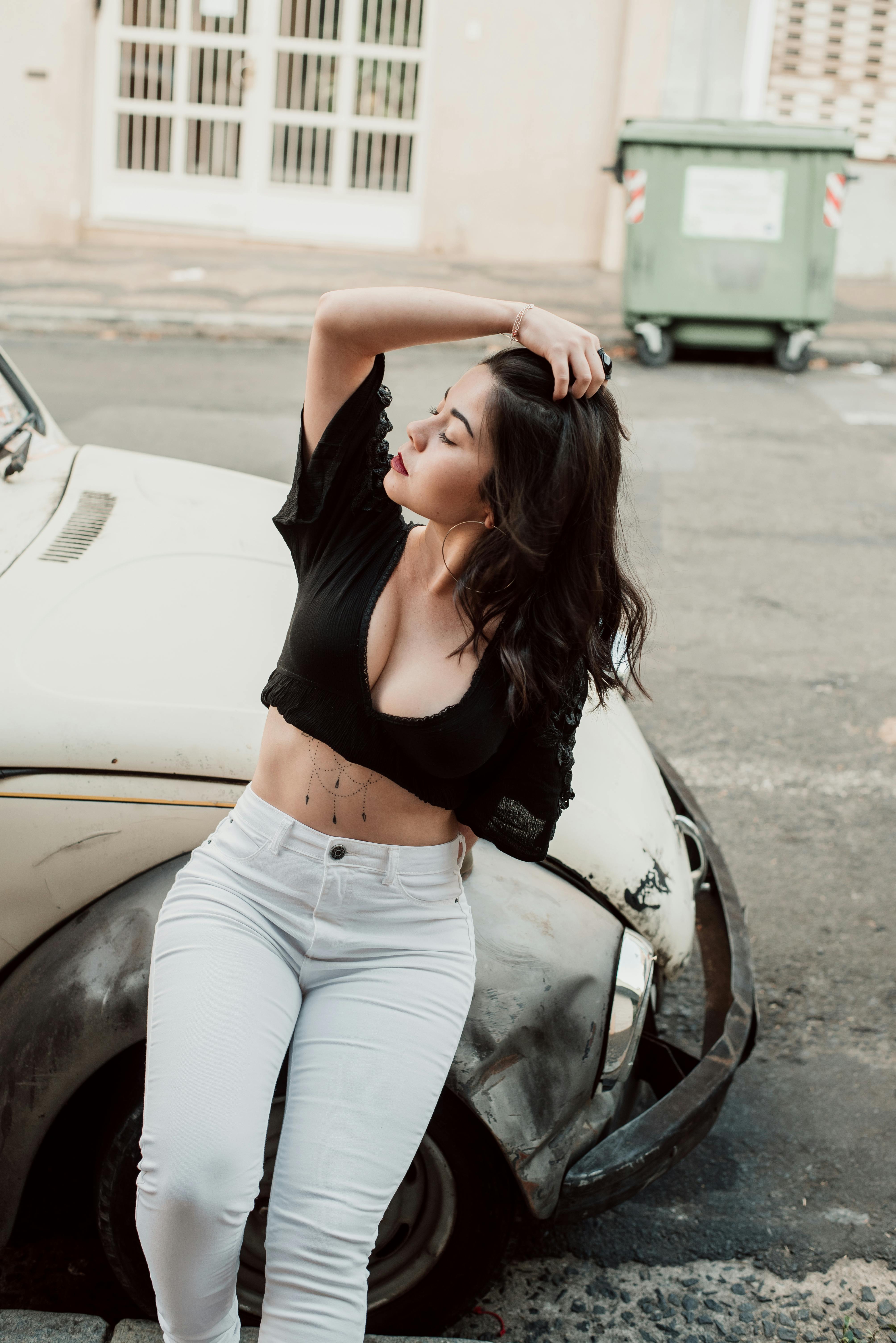 Photo of Posing Woman Leaning on Old VW Bettle