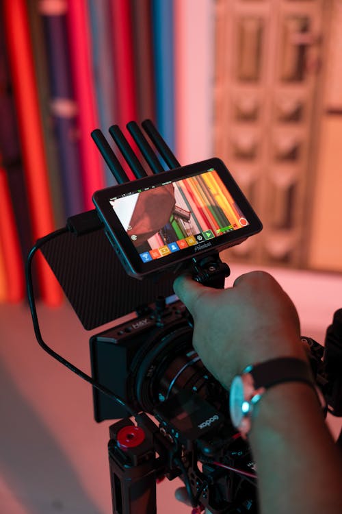 Man Holding a Camera in a Studio 