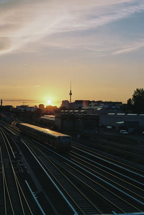 Free Stunning view of Berlin skyline with train tracks at sunset, highlighting urban life. Stock Photo