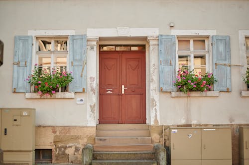 Free Facade of a House with Wooden Shutters  Stock Photo