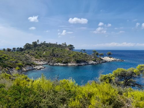 Free Beautiful coastal view of Skopelos Island, Greece with clear blue waters and lush greenery under a sunny sky. Stock Photo