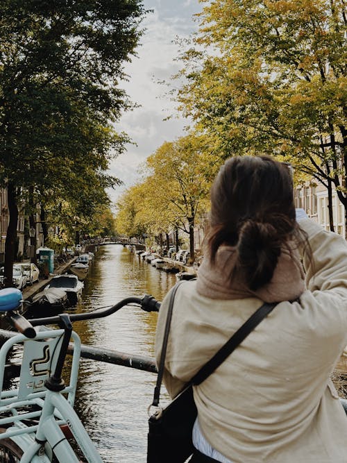 Woman Looking at River in Amsterdam