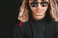 Man Wearing Black Cable-knit Crew-neck Sweater While Taking a Photo