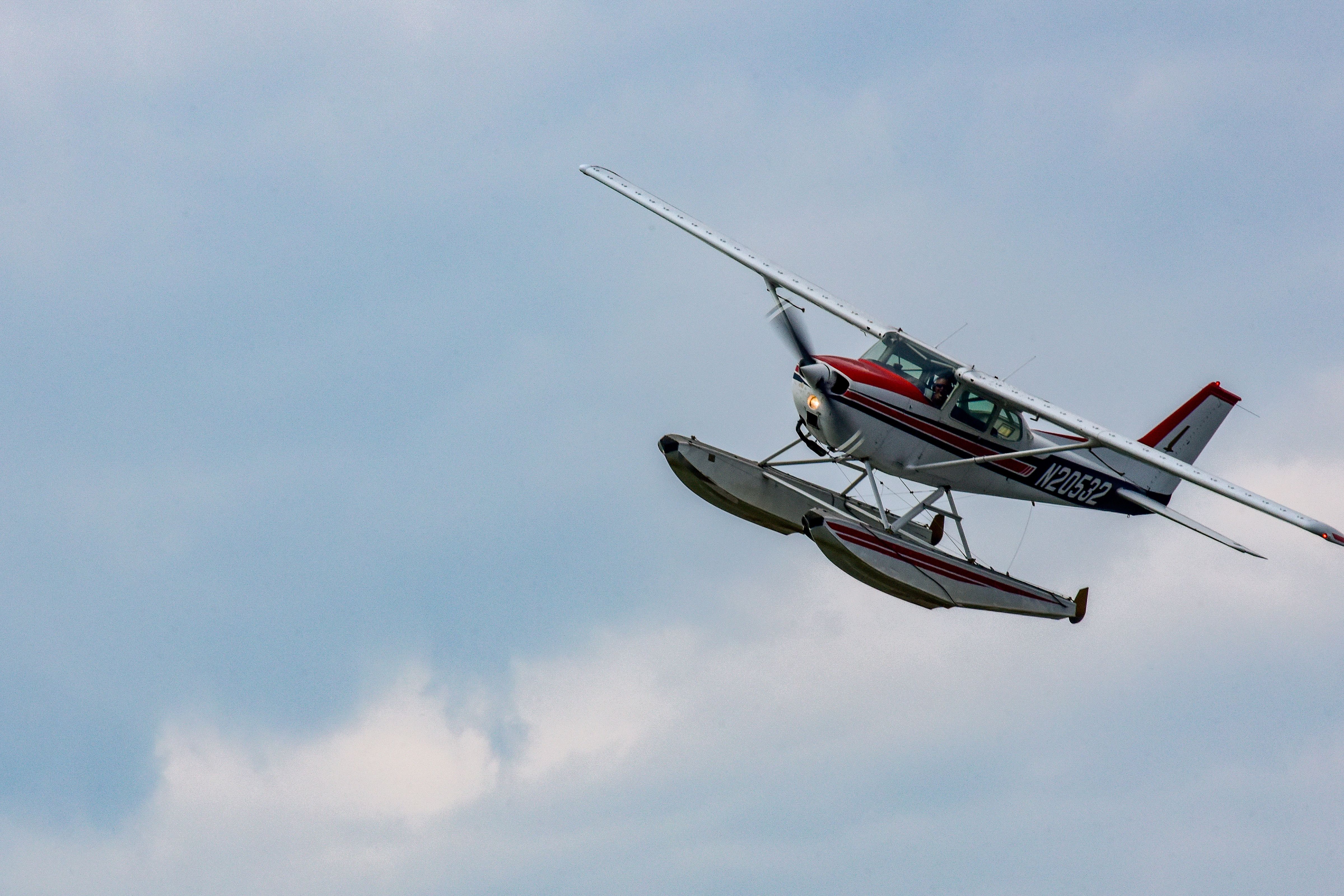 A floatplane gracefully flying in the clear blue sky over Grand Rapids, MN. — lounges at Grand Rapids Airport