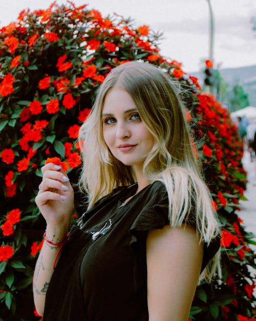 Blonde Woman Portrait near Flowers