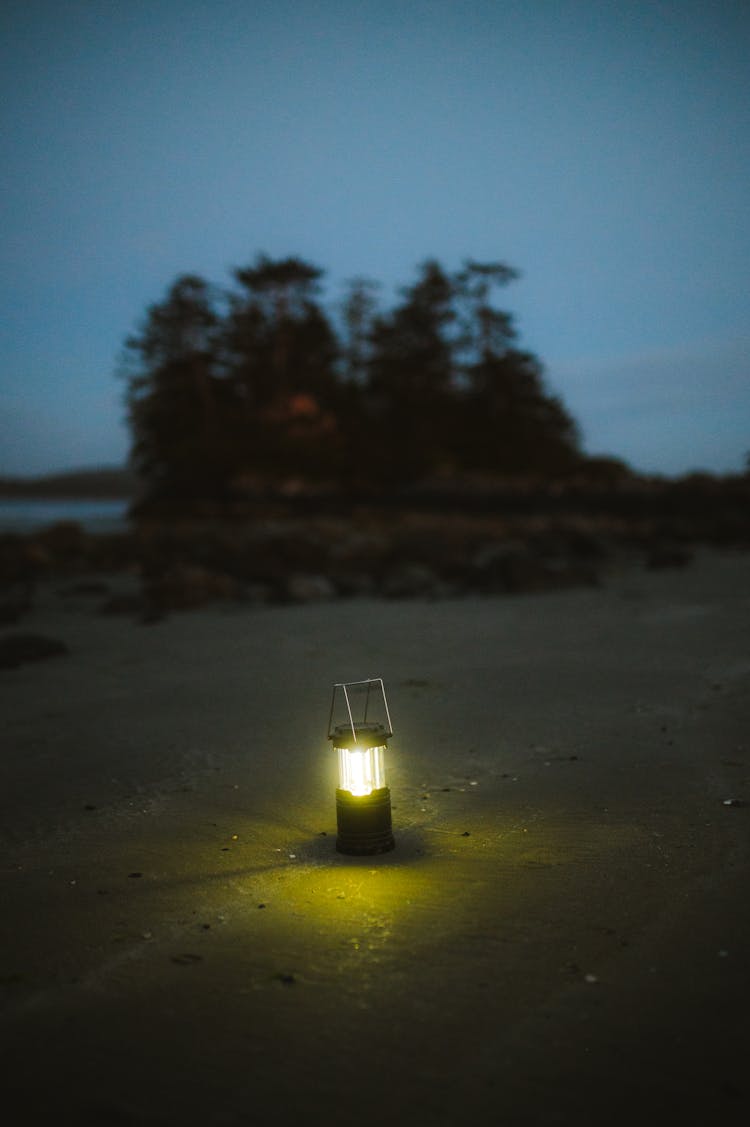 Retro Lantern Shining On A Beach In The Evening