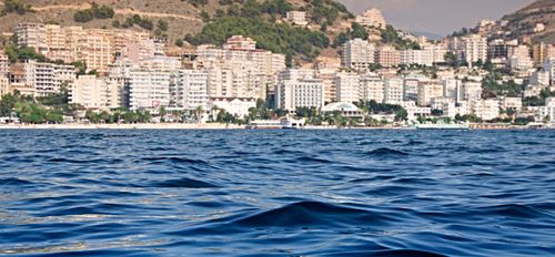 Free Beautiful view of the Sarandë waterfront with buildings along the seashore. Stock Photo