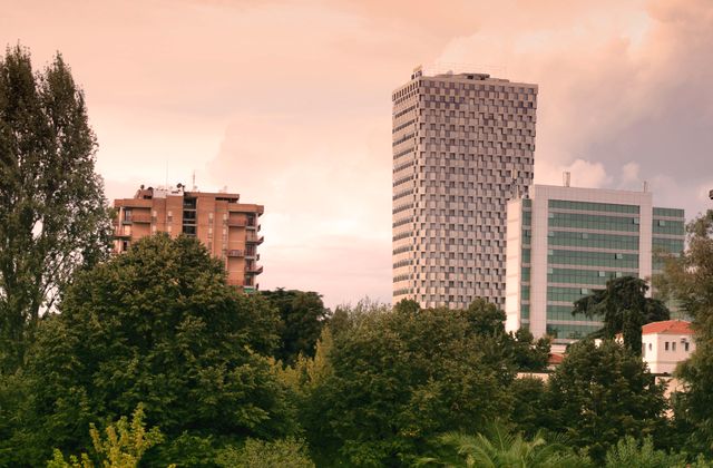 View of modern skyscrapers and lush greenery in Tirana, Albania during daylight. — arriving in Rinas