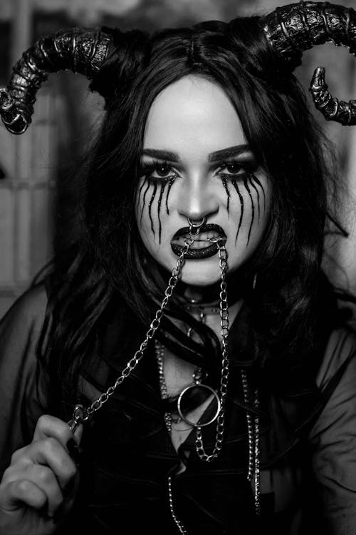 Woman Wearing a Halloween Costume with a Chain in her Mouth 