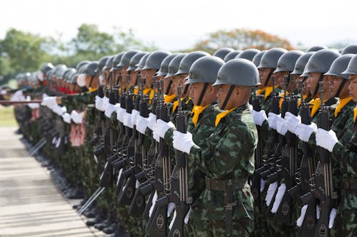 Free Group of ethnic soldiers marching during parade Stock Photo
