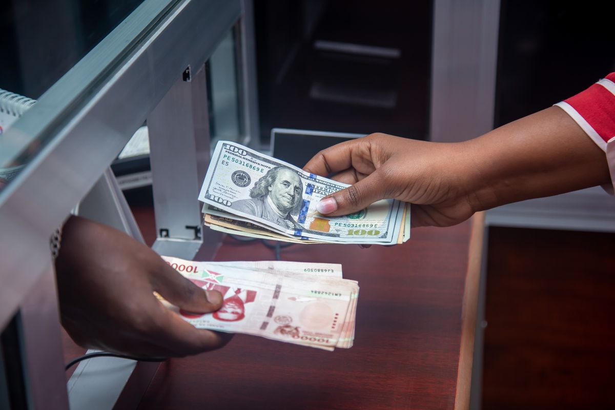 Hands exchanging currency at bank counter