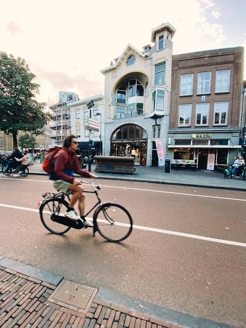 Man Riding a Bike on a Street in Amsterdam