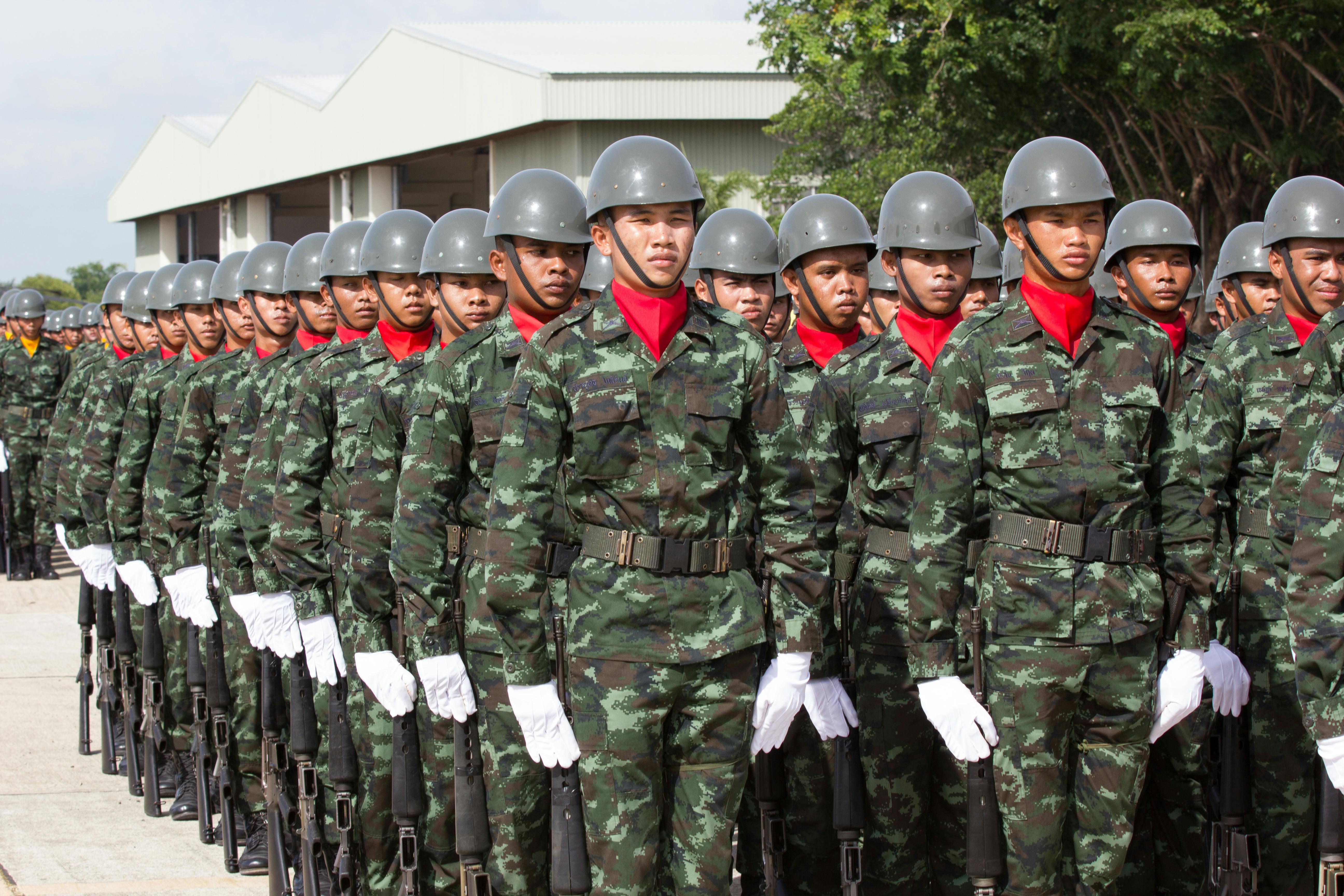 serious ethnic soldiers lining up during military ceremony