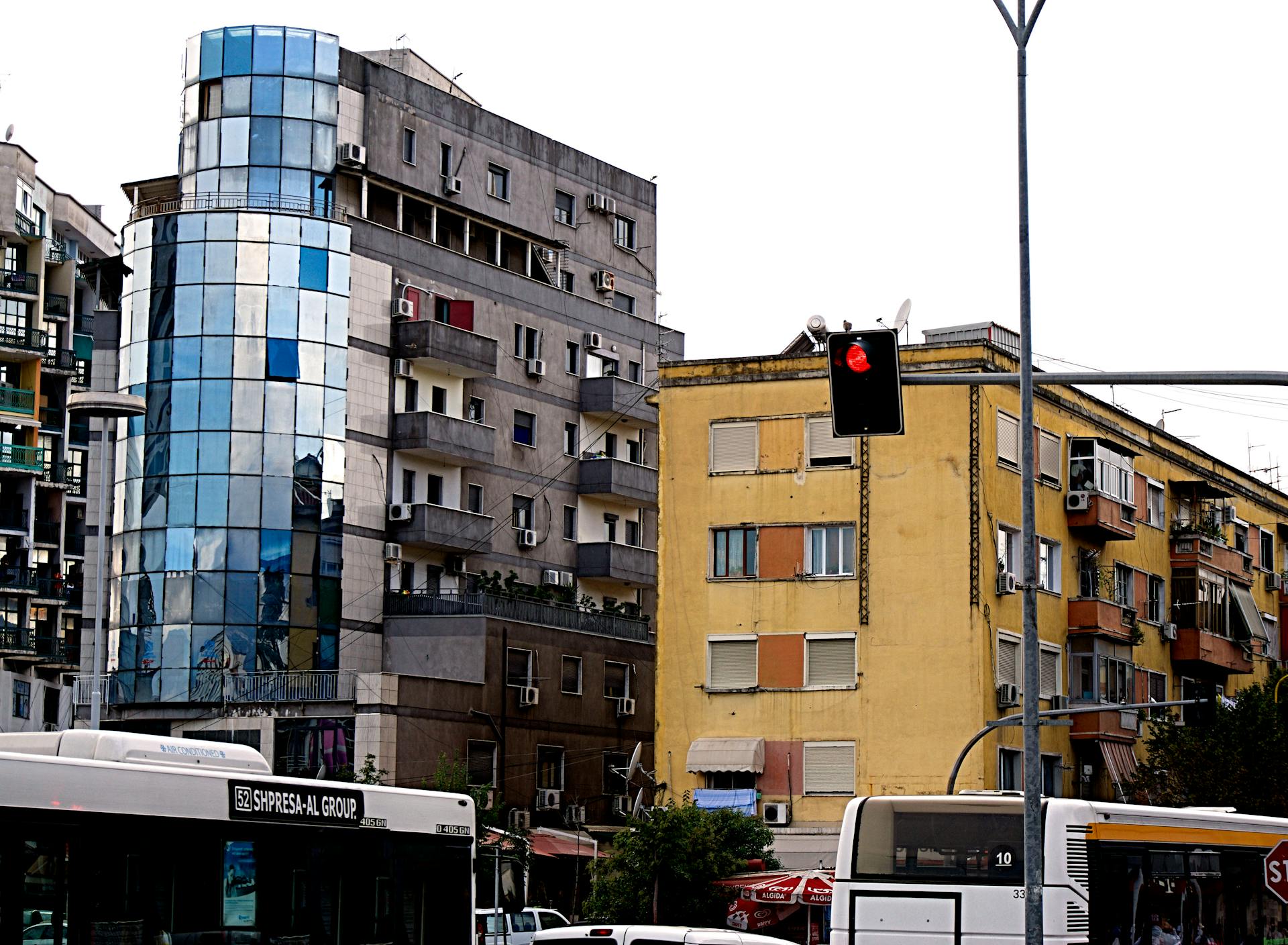 A vibrant cityscape of Tirana showcasing modern buildings and traffic activity.